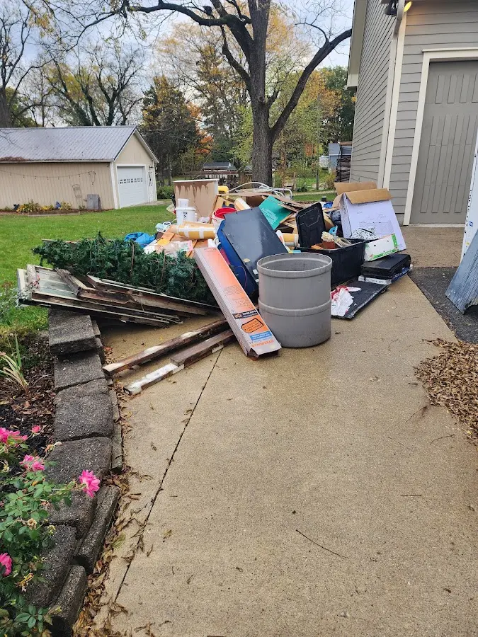 Dumpster being loaded with debris for 12 Yard Dumpster Rental in Winona
